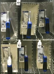 Notched trowels used to spread tile adhesive evenly on a substrate