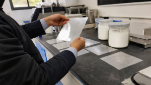 Procurement specialist inspecting coded RDP film samples in a materials laboratory